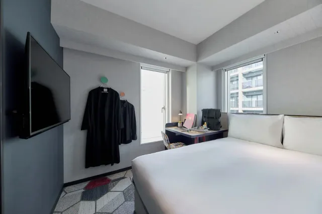 lyf Shibuya Tokyo contemporary guest room with bed and city-facing windows