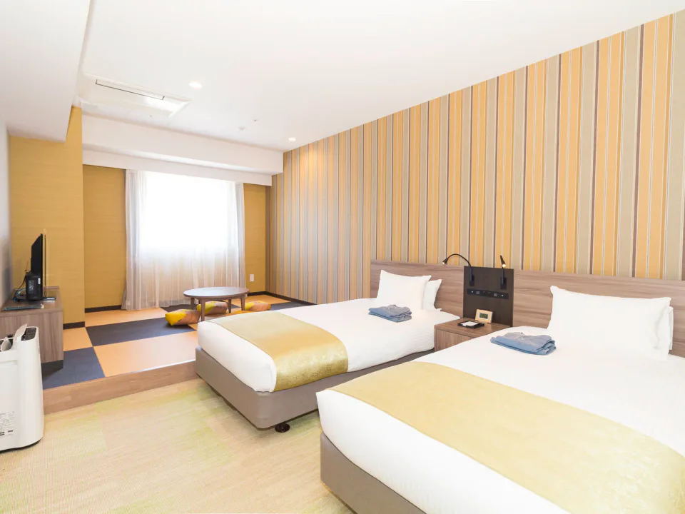 La'gent Stay Hakodate Ekimae deluxe family room with twin beds and tatami seating