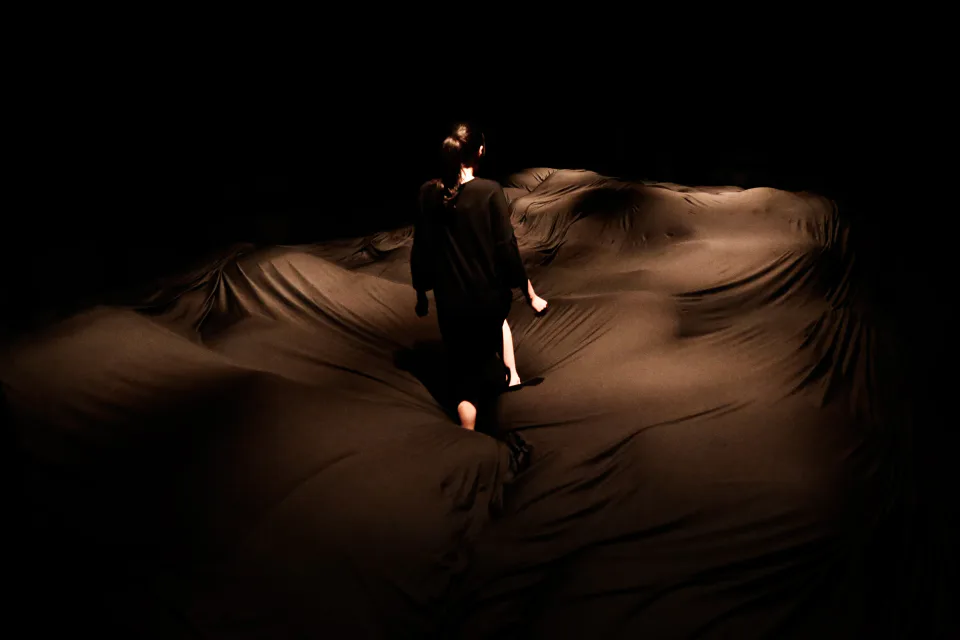Soft Black Hole at teamLab Planets with visitors walking across the soft sinking black surface