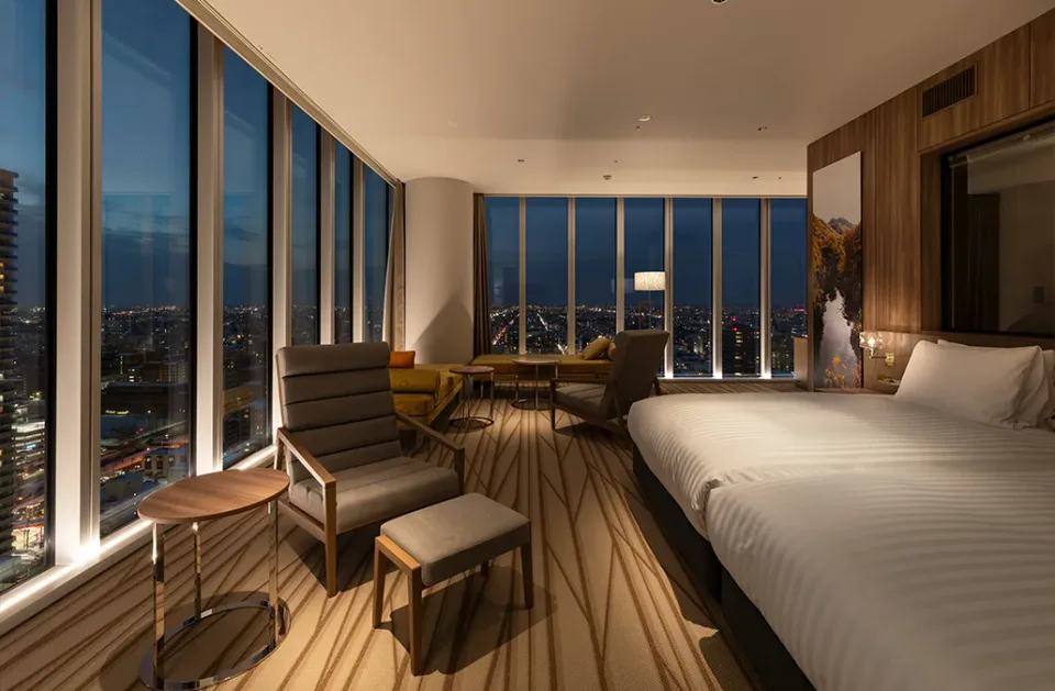 SAPPORO HOTEL by GRANBELL corner suite bedroom and city-view seating area