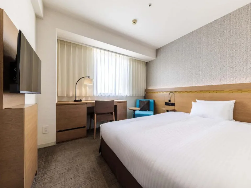 Nishitetsu Hotel CROOM Hakata compact guest room with bed, desk and seating