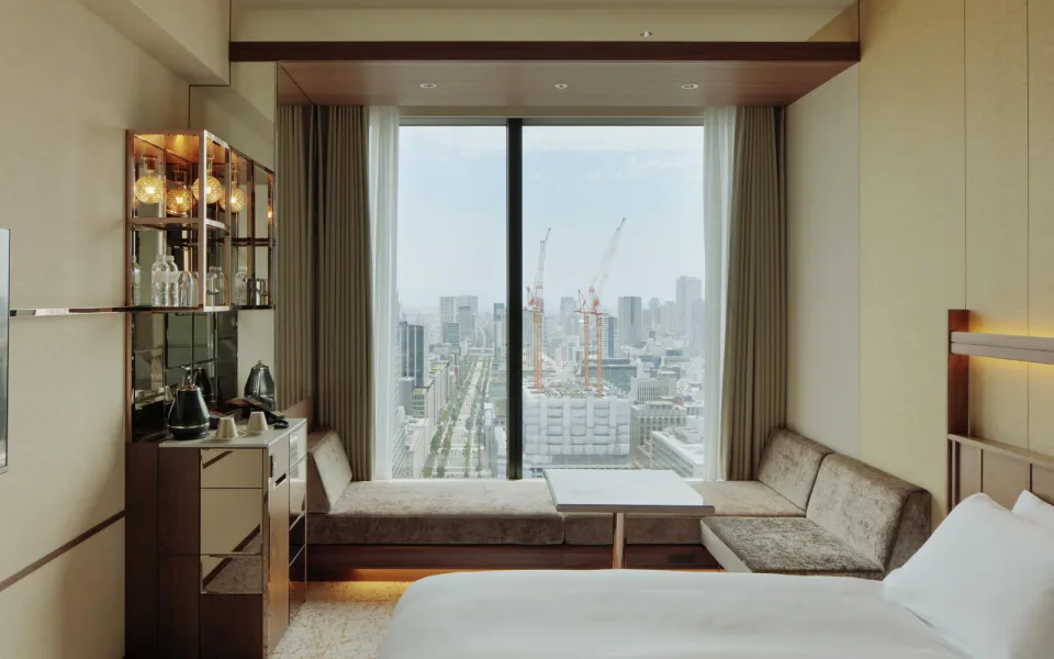 CANDEO HOTELS Osaka The Tower guest room with bed, window seating and city view