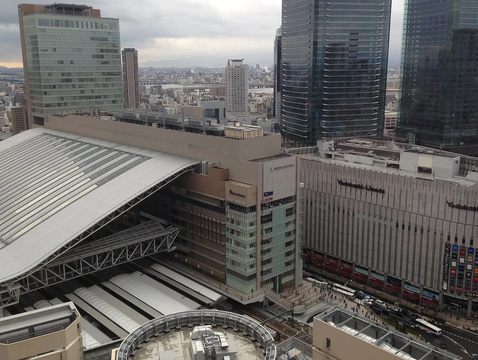 Osaka Station in May, where warm walking days favour compact, removable layers