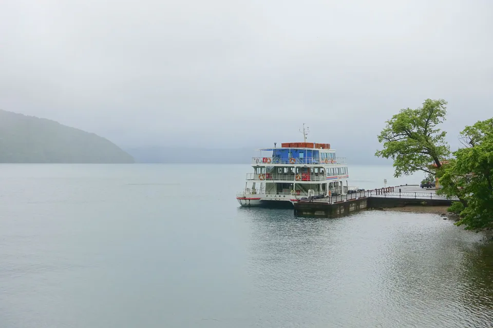 Lake Towada sightseeing boat with autumn mountains