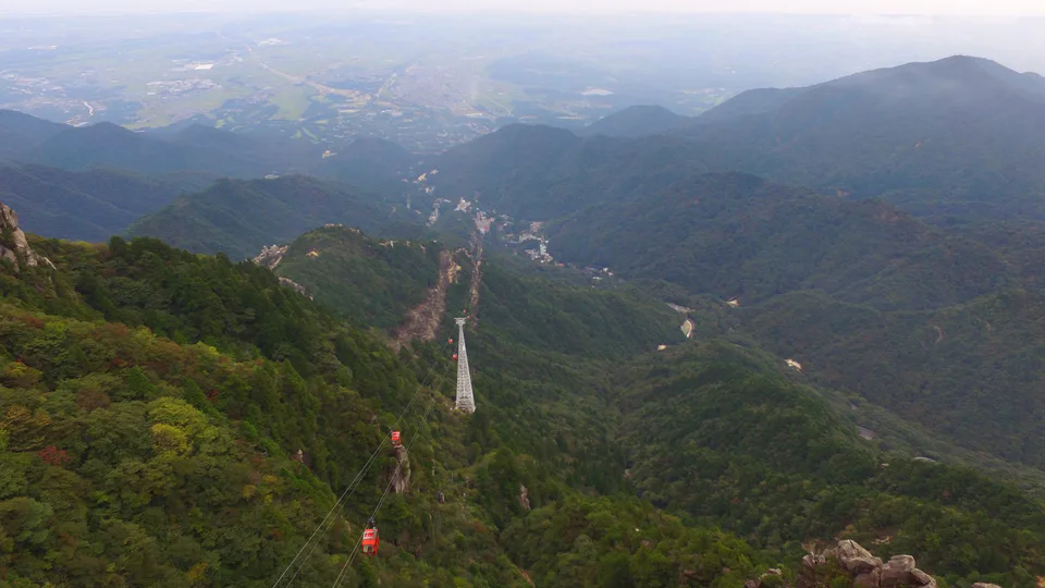 View from Mount Gozaisho over the ropeway line, white support tower and Yunoyama Onsen below