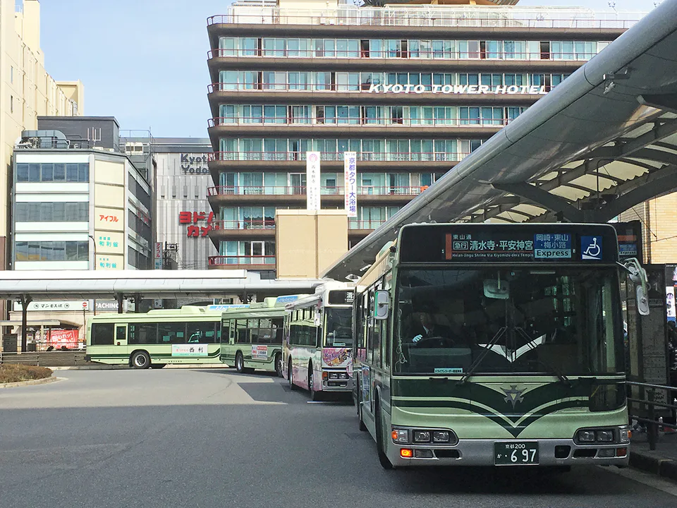 Kyoto Station bus area during a busy season, where rail should replace the first congested transfer