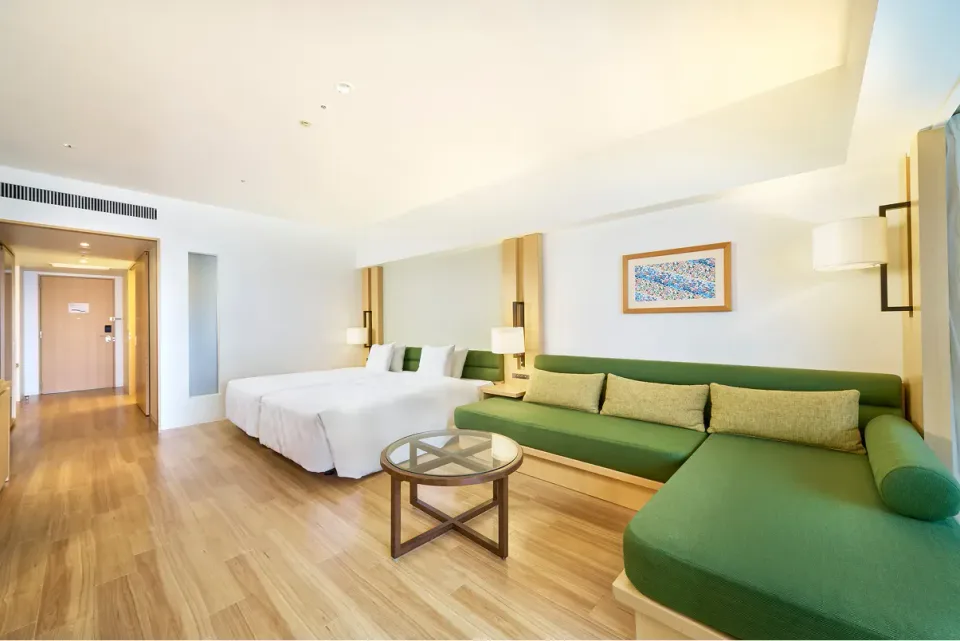 The Orion Hotel Motobu Resort and Spa bright Ocean Wing room with green sofa and twin beds