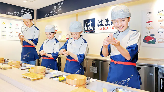 A child working as a sushi chef at KidZania Fukuoka, an example of a hands-on food activity that may be worth ranking before arrival