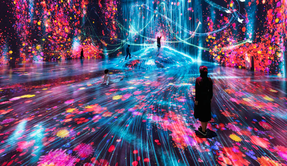 Universe of Water Particles at teamLab Borderless Tokyo with flowing digital water and flowers around visitors