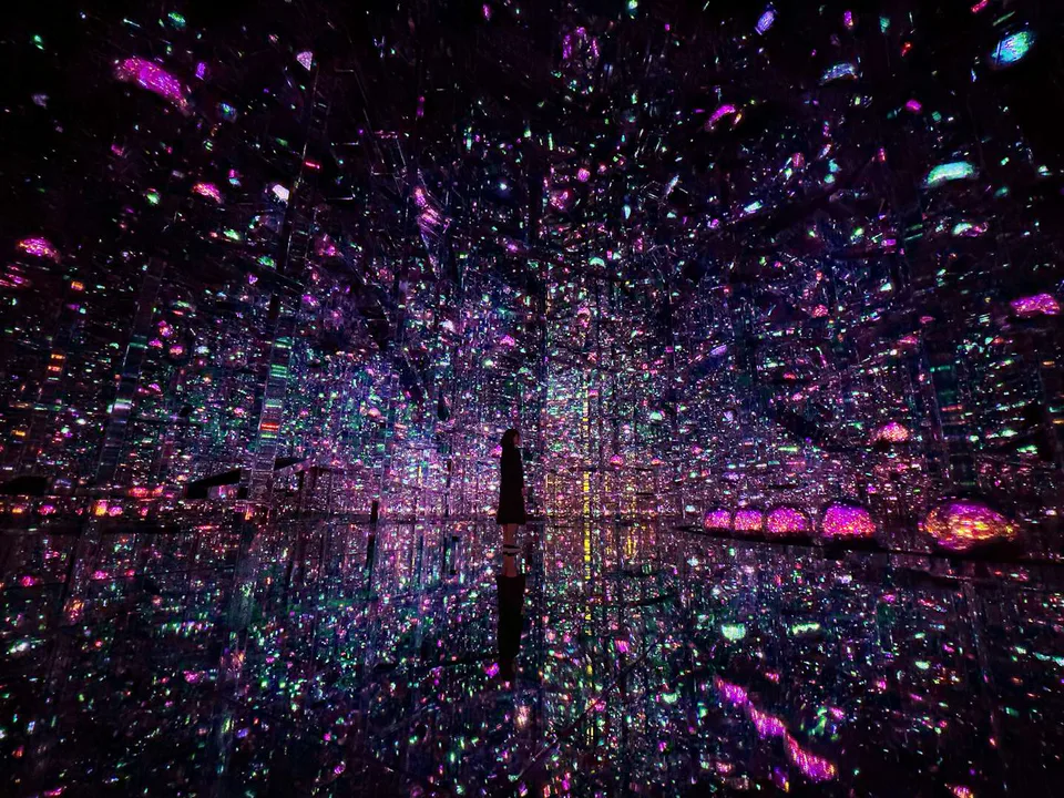 Infinite Crystal World at teamLab Borderless with mirrored reflections and countless colored light points