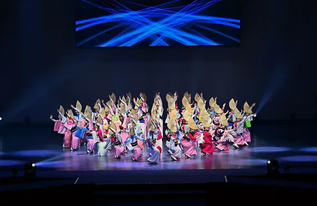 Awa Odori dance troupe performing on an indoor stage