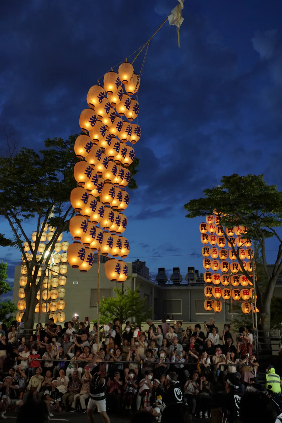 Illuminated lantern poles raised during the Akita Kanto Festival night performance