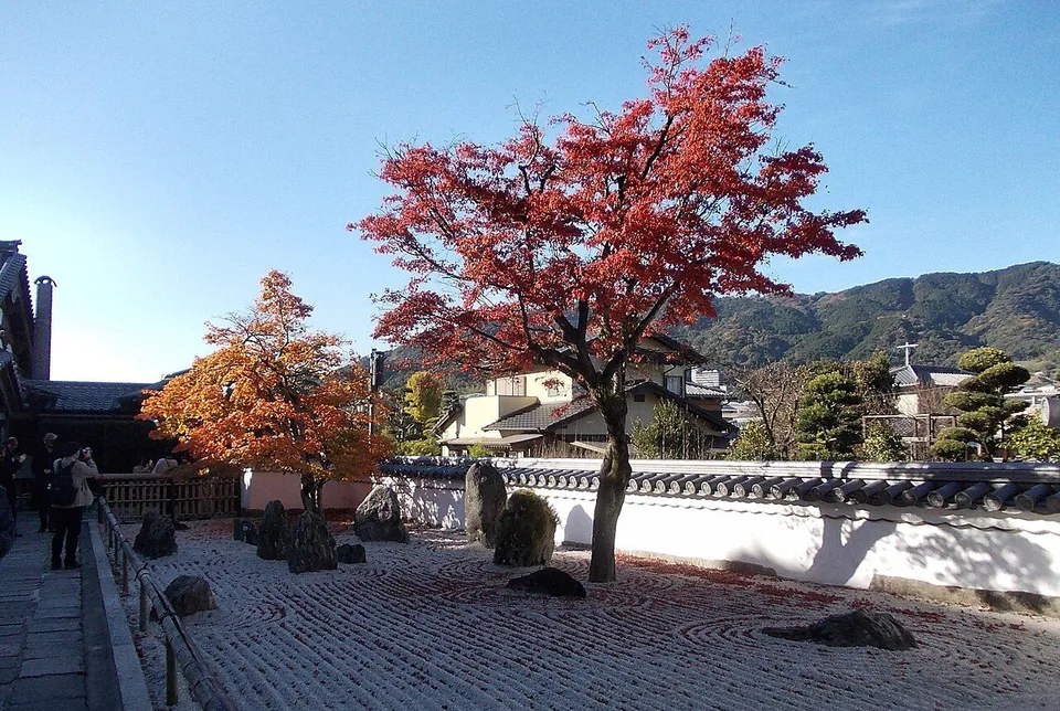 Red and orange maples around the stone garden at Komyozenji Temple in Dazaifu
