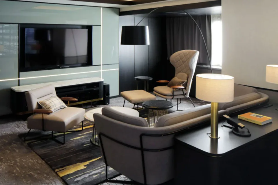 CROSS HOTEL OSAKA suite living room with sofa seating and television