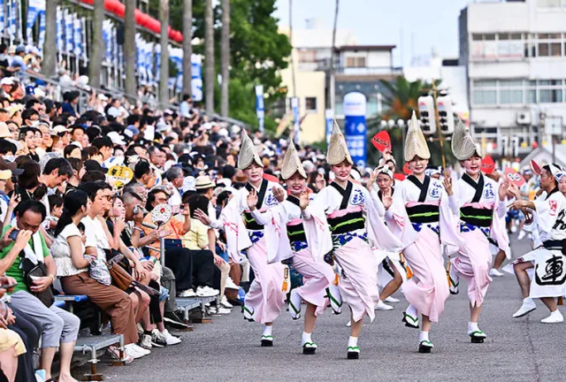 Awa Odori dancers performing along a Tokushima street