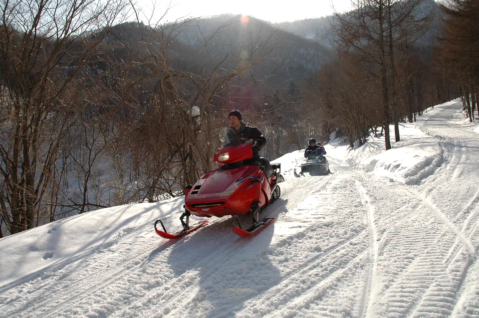 Sapporo Snowmobile Land mountain trail in winter, comparing 30-, 60- and 90-minute snowmobile experiences.