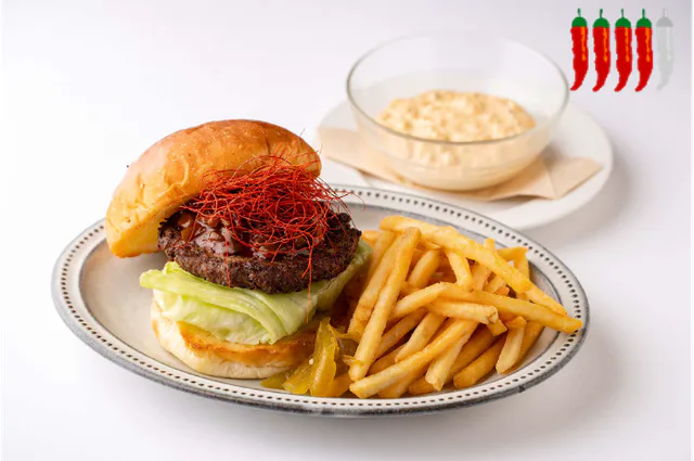 ARK Hills Cafe spicy jalapeno burger with Carolina Reaper sauce during the 2026 event