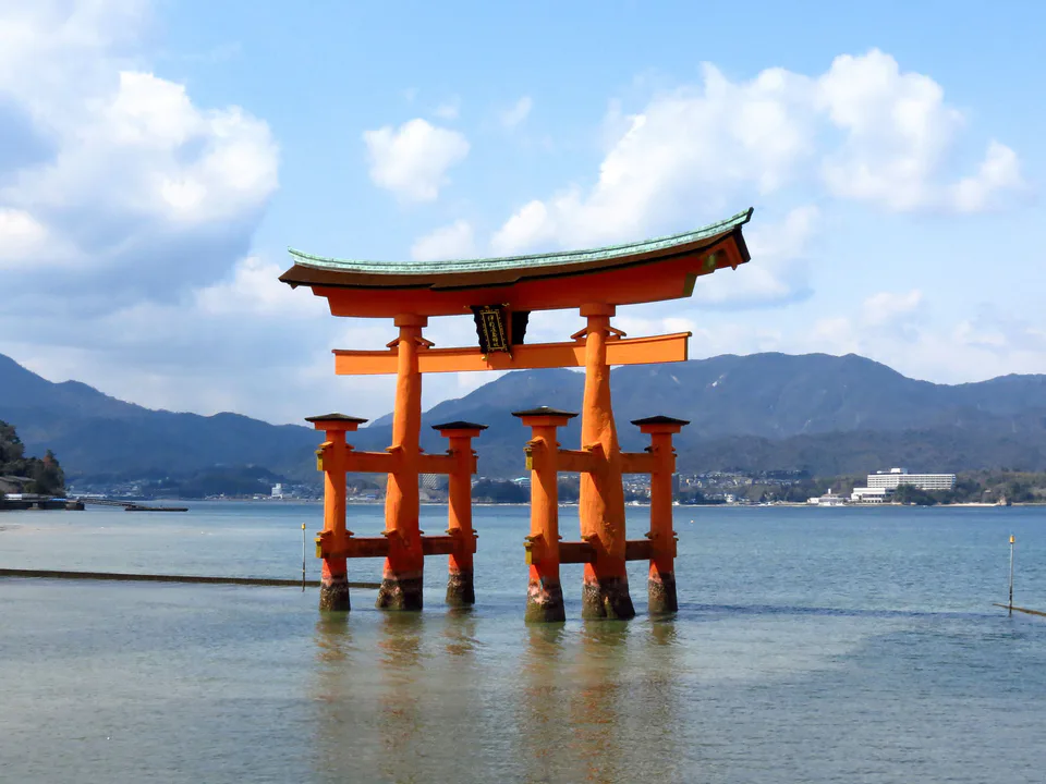 Itsukushima Shrine and Great Torii surrounded by water at high tide on Miyajima