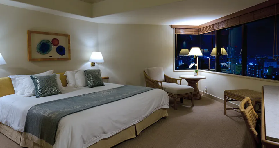 The Naha Terrace club king guest room with bed and lounge seating