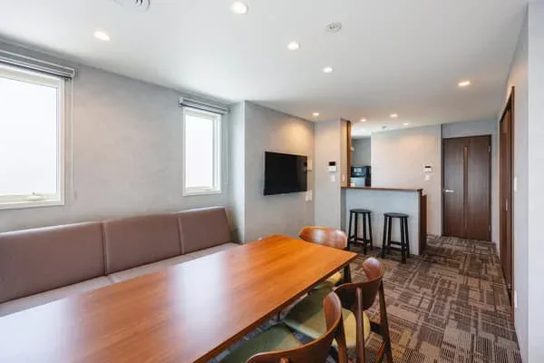 KOKO HOTEL Residence Tokyo Oshiage guest room with living, dining and kitchen area