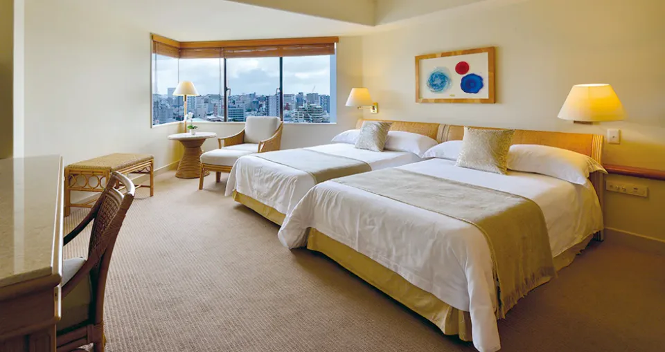 The Naha Terrace deluxe twin guest room with two beds