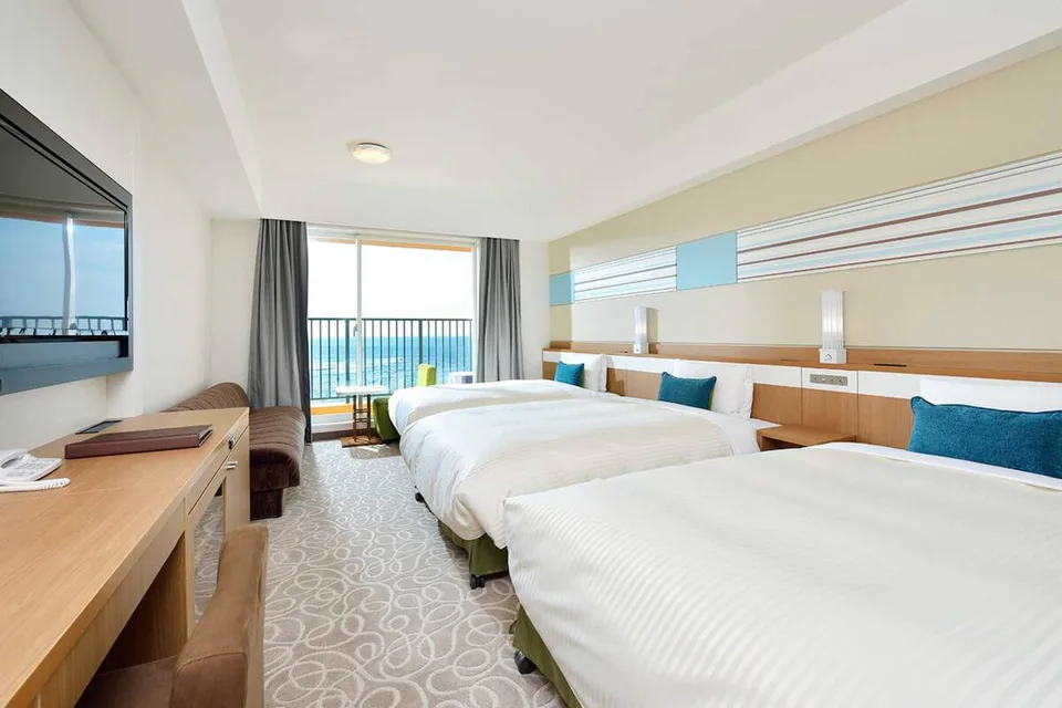Okinawa family hotel room at Vessel Hotel Campana Okinawa with three beds and ocean view