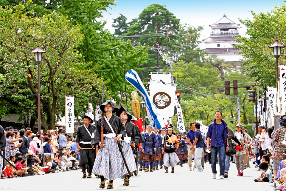 Aizu Festival samurai procession with Tsuruga Castle in the background