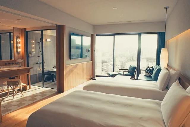 Southwest Grand Hotel Okinawa guest room with twin beds and wood interior